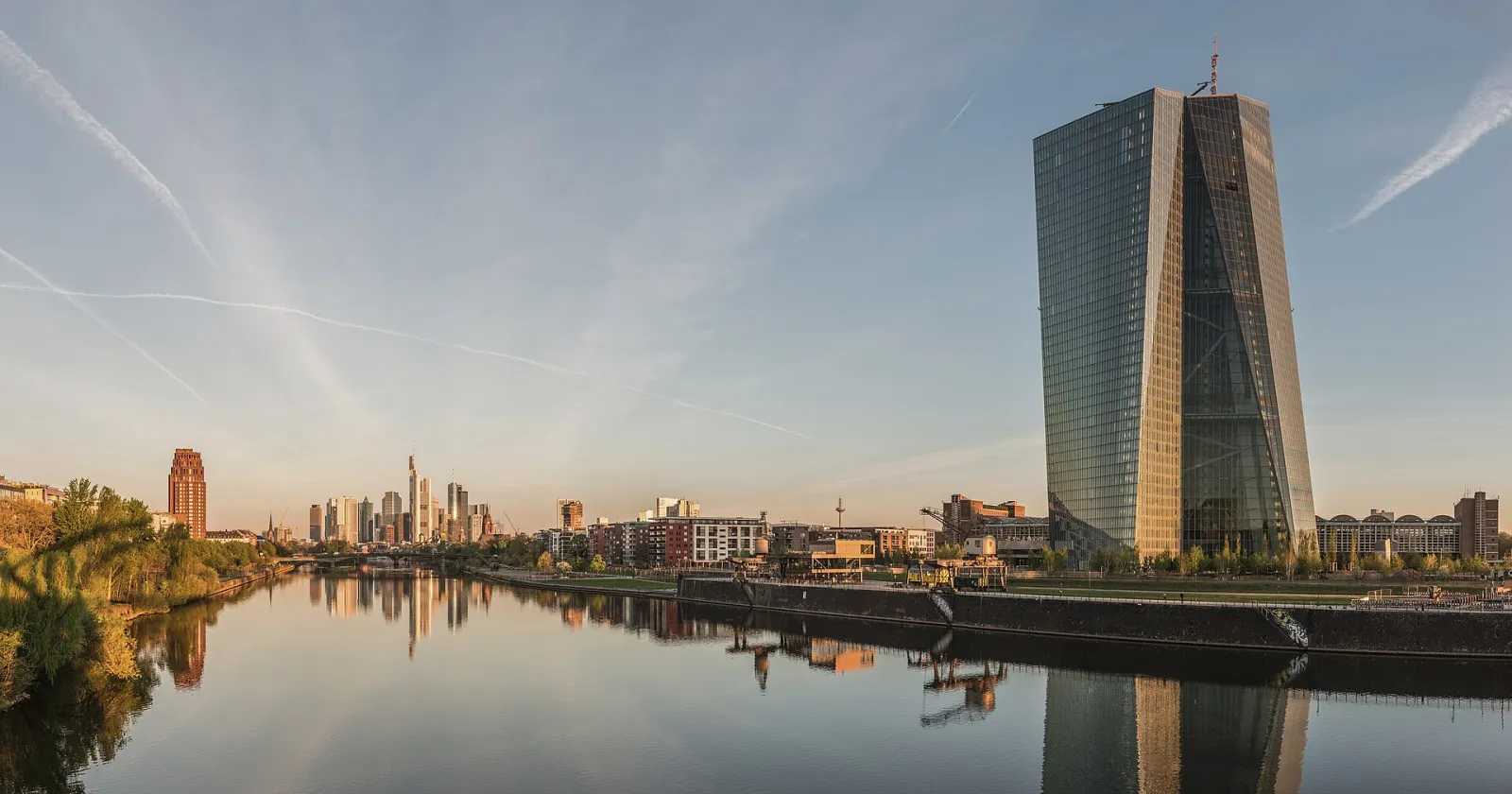 Frankfurt skyline at dawn with the European Central Bank headquarters in the foreground beside the river Main